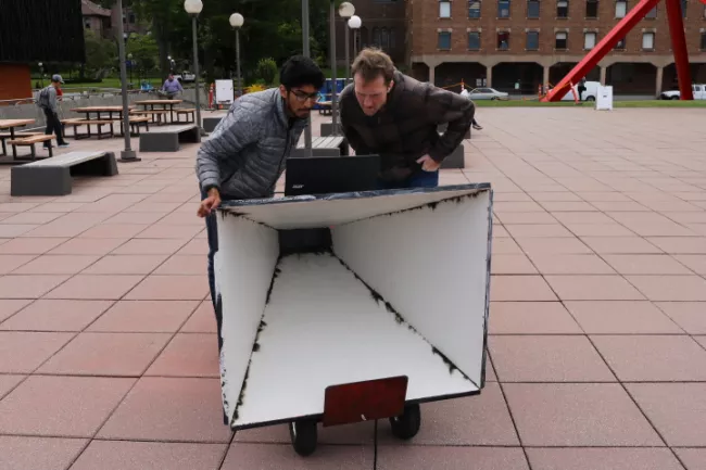 Two EECE students working on a project outside