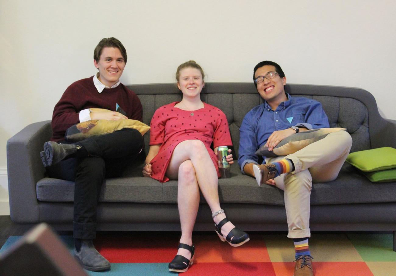Three ID students sitting on a couch together 